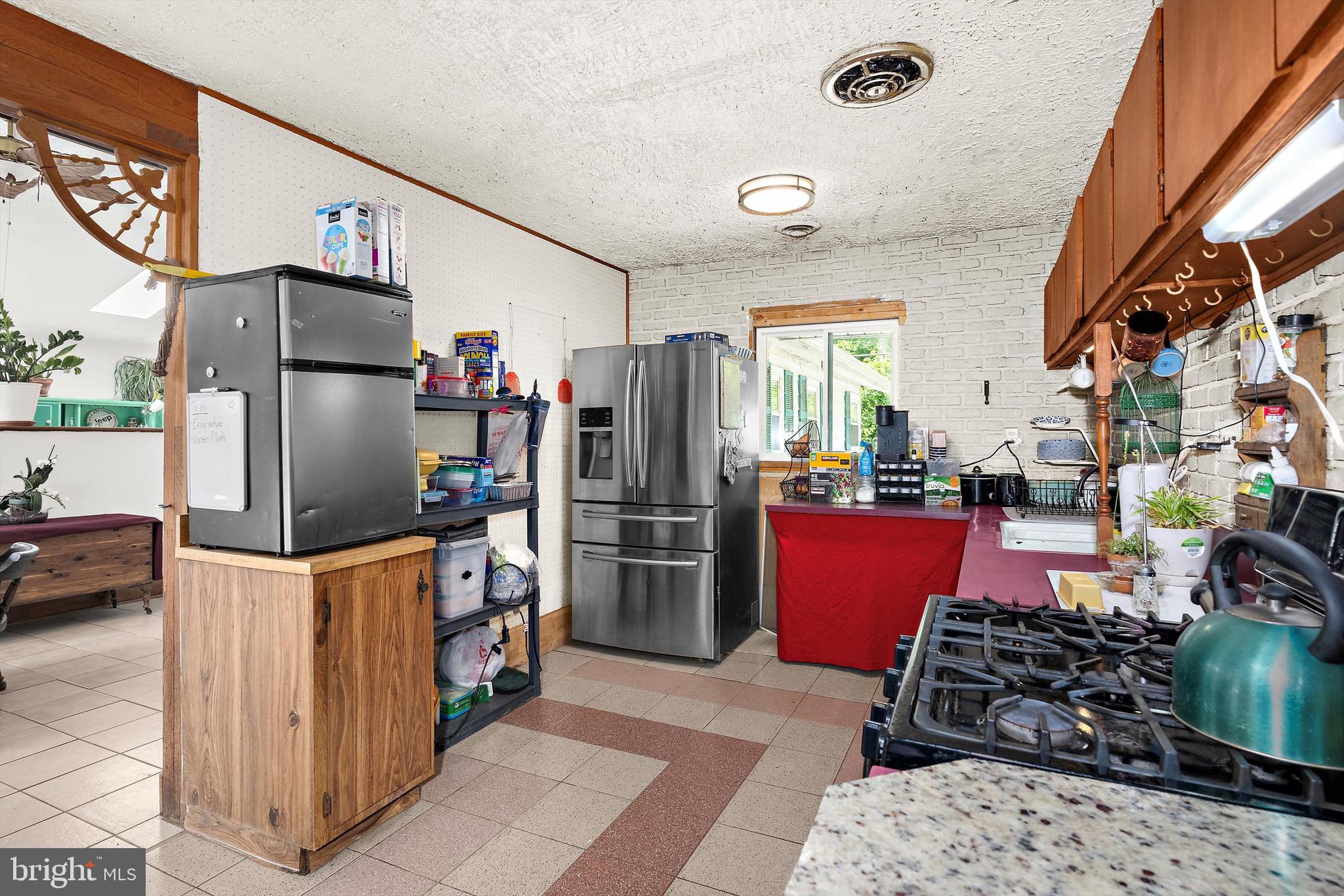 902 Joppa Farm Road Joppa, MD 21085 - Photo 14 of 34 a kitchen with stainless steel appliances kitchen island granite countertop a refrigerator stove and sink