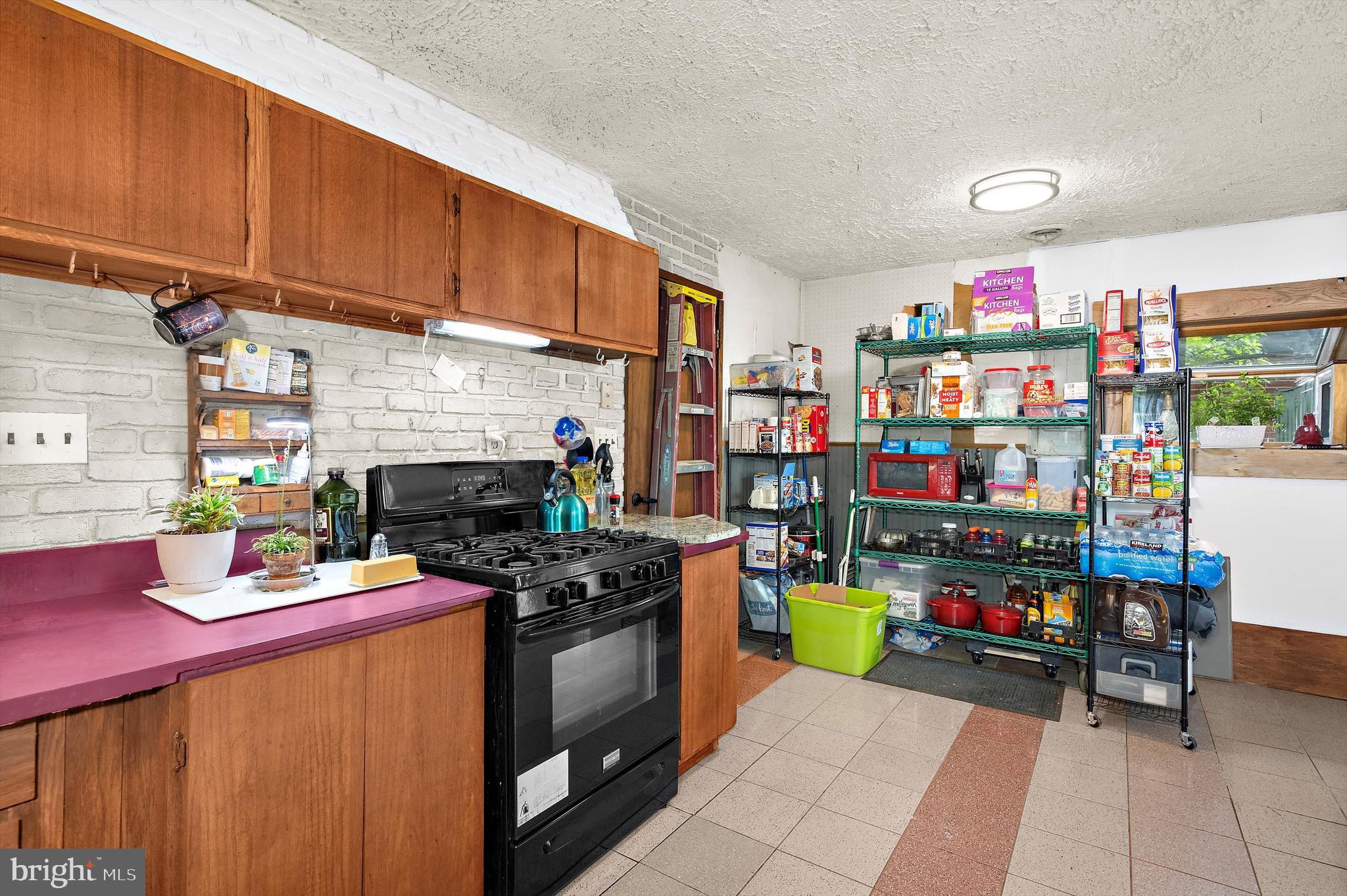 902 Joppa Farm Road Joppa, MD 21085 - Photo 15 of 34 a kitchen with lots of clutter and stainless steel appliances