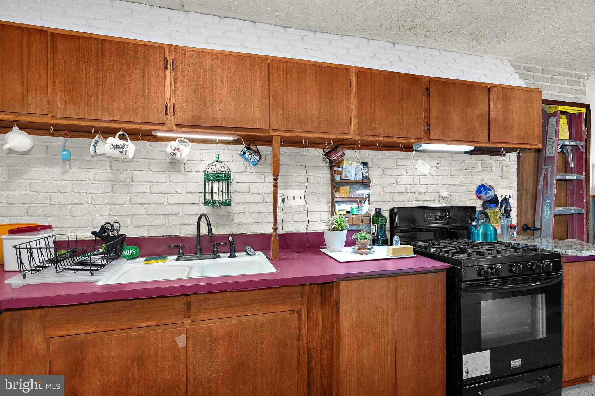 902 Joppa Farm Road Joppa, MD 21085 - Photo 16 of 34 a kitchen with stainless steel appliances a sink dishwasher stove and cabinets