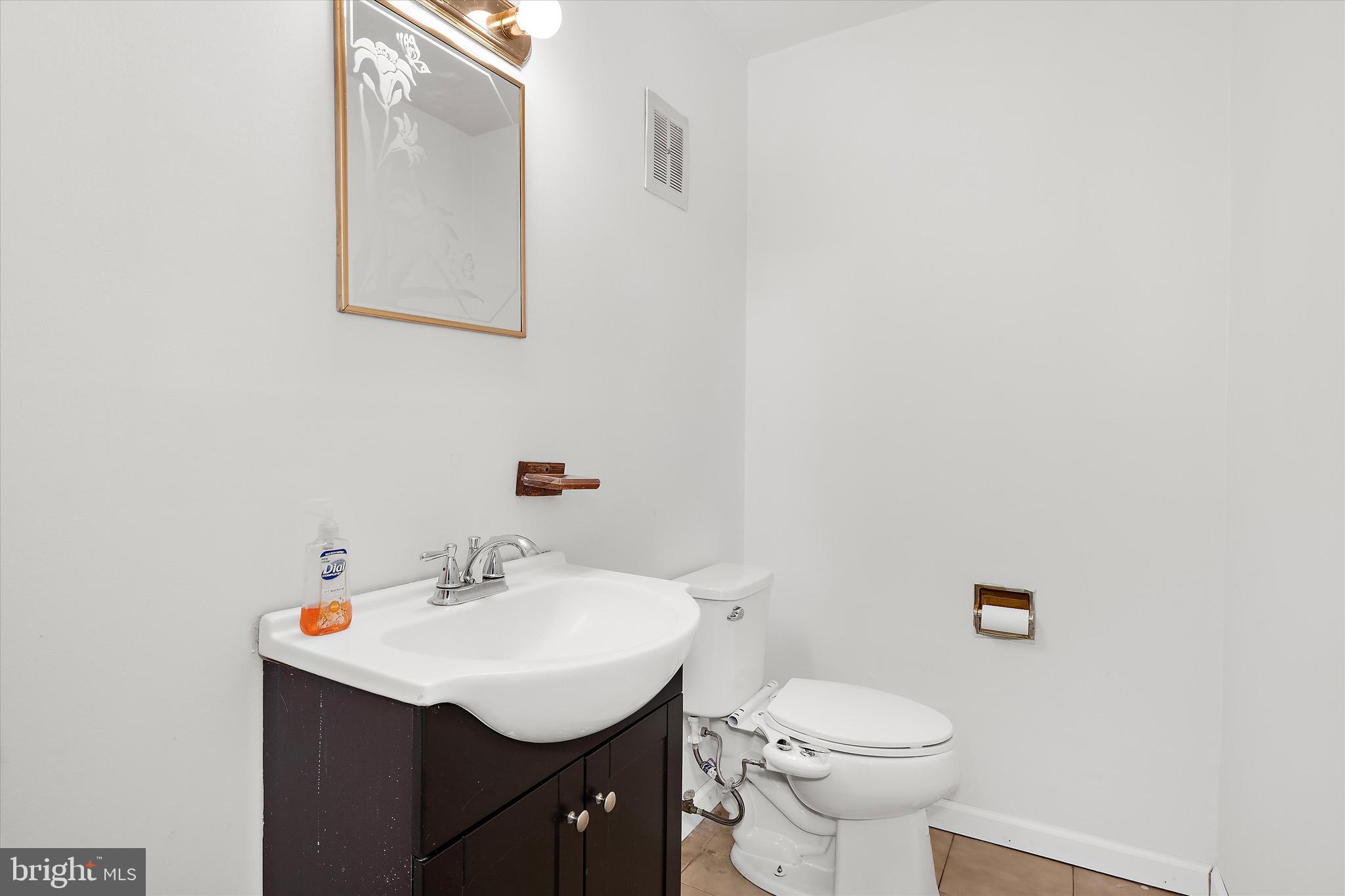 902 Joppa Farm Road Joppa, MD 21085 - Photo 17 of 34 a bathroom with a sink toilet and a mirror