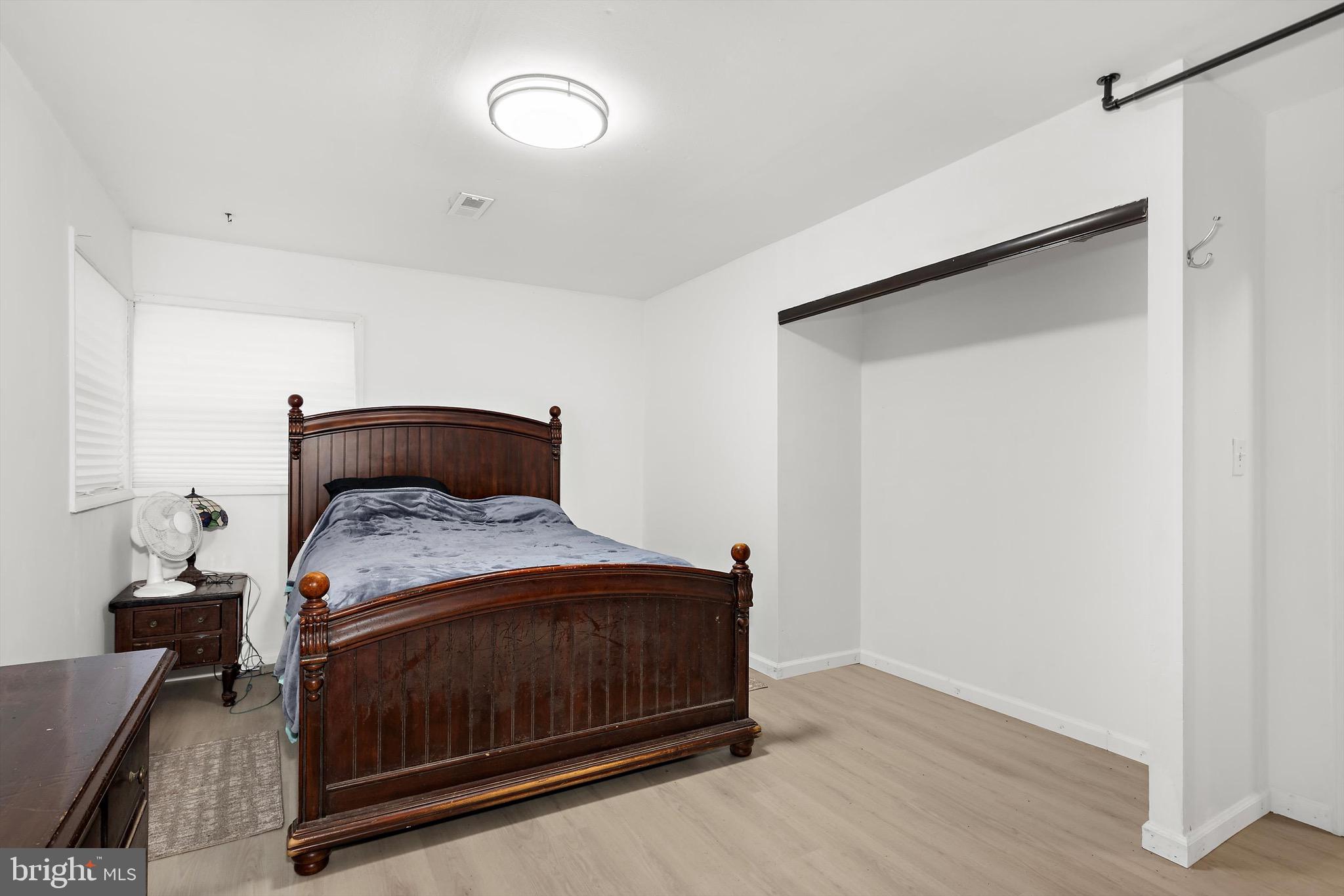 902 Joppa Farm Road Joppa, MD 21085 - Photo 25 of 34 a bedroom with a bed and wooden floor