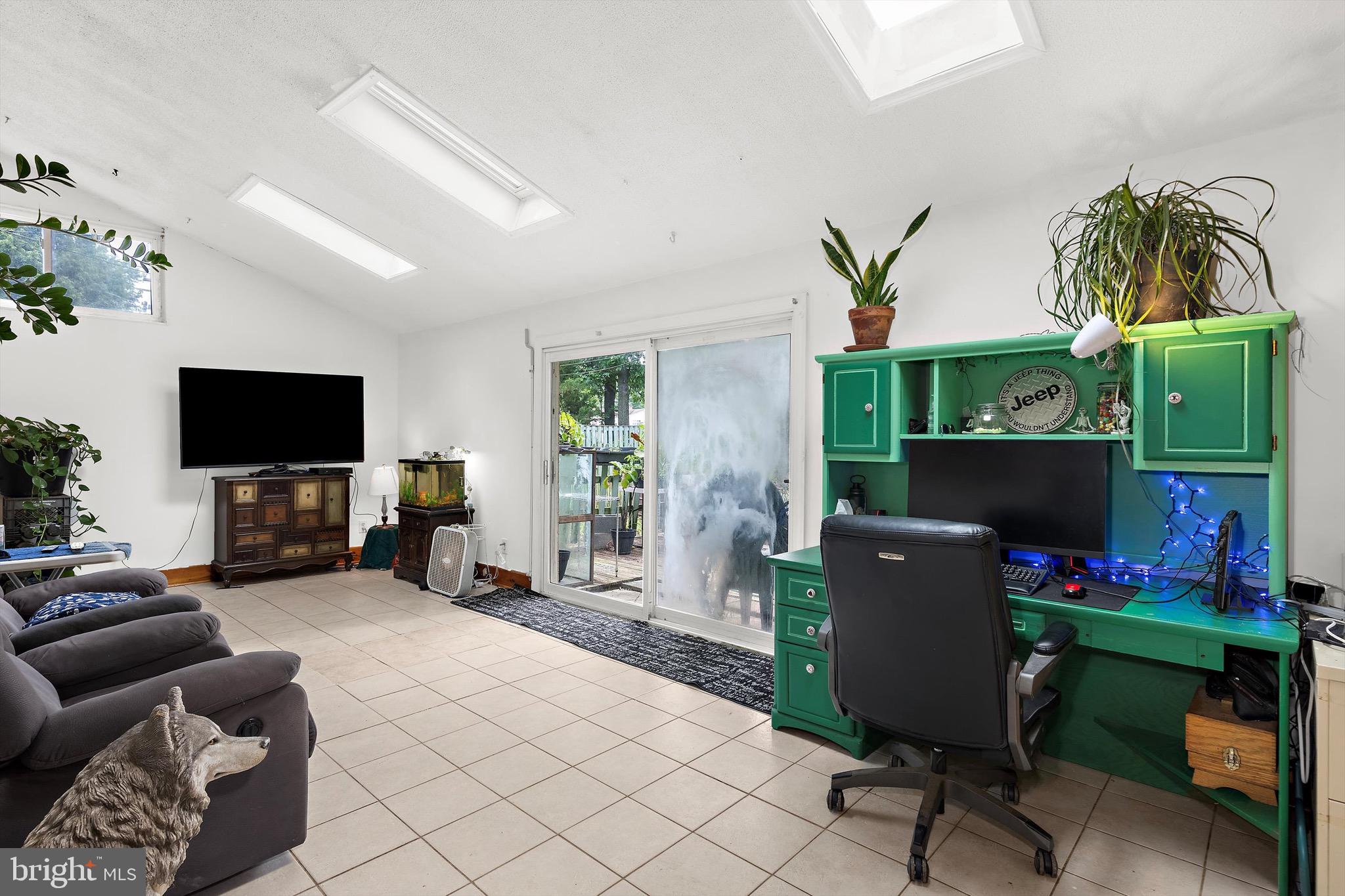 902 Joppa Farm Road Joppa, MD 21085 - Photo 6 of 34 a living room with furniture a flat screen tv and a floor to ceiling window