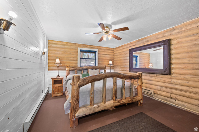 4725 Pine Ridge Road Evanston, UT 82930 - Photo 20 of 82 Interior room featuring a wood-finish bed frame, wood-paneled walls, and a white plank wall