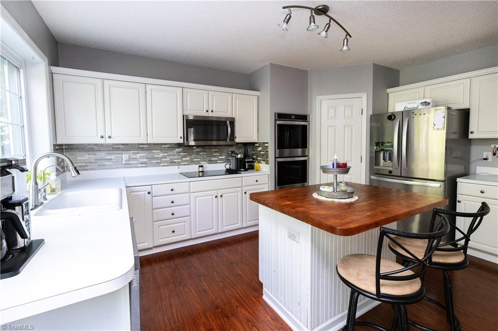 1403 Spring Tree Court High Point, NC 27265 - Photo 11 of 35 Kitchen view. Pantry is between double oven and fridge.