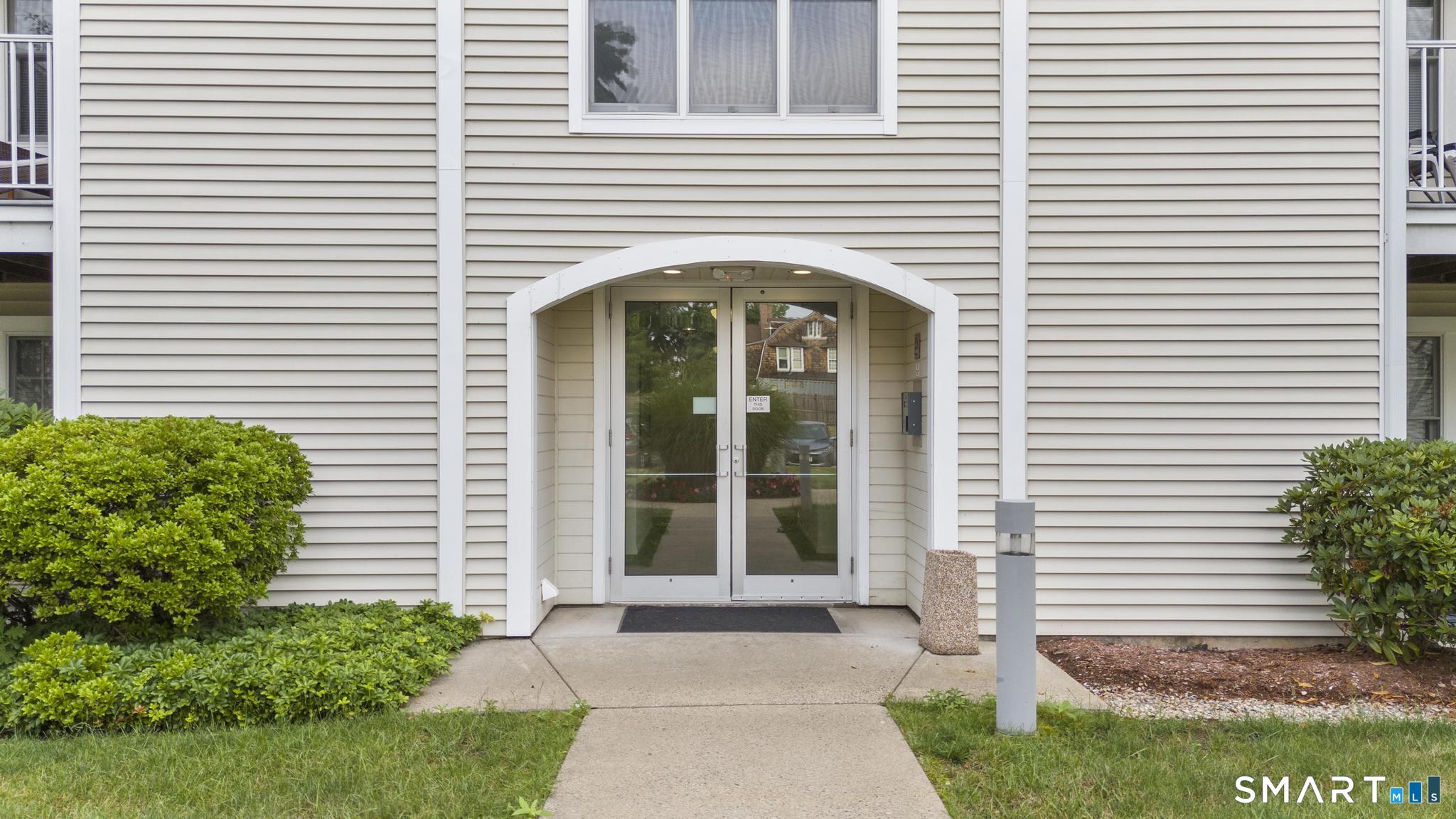 468 Main Street, Unit 111 East Lyme, CT 06357 - Photo 11 of 37 a front view of a house with a porch