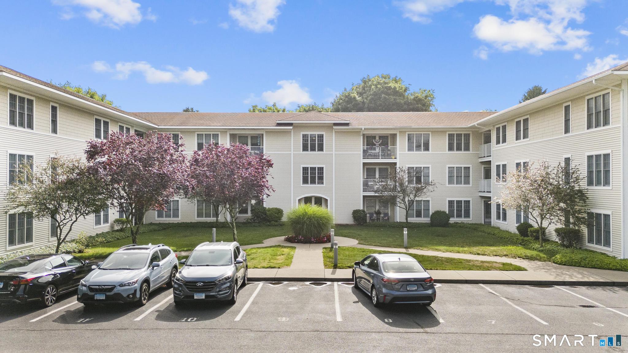 468 Main Street, Unit 111 East Lyme, CT 06357 - Photo 16 of 37 a front view of a house with swimming pool having outdoor seating