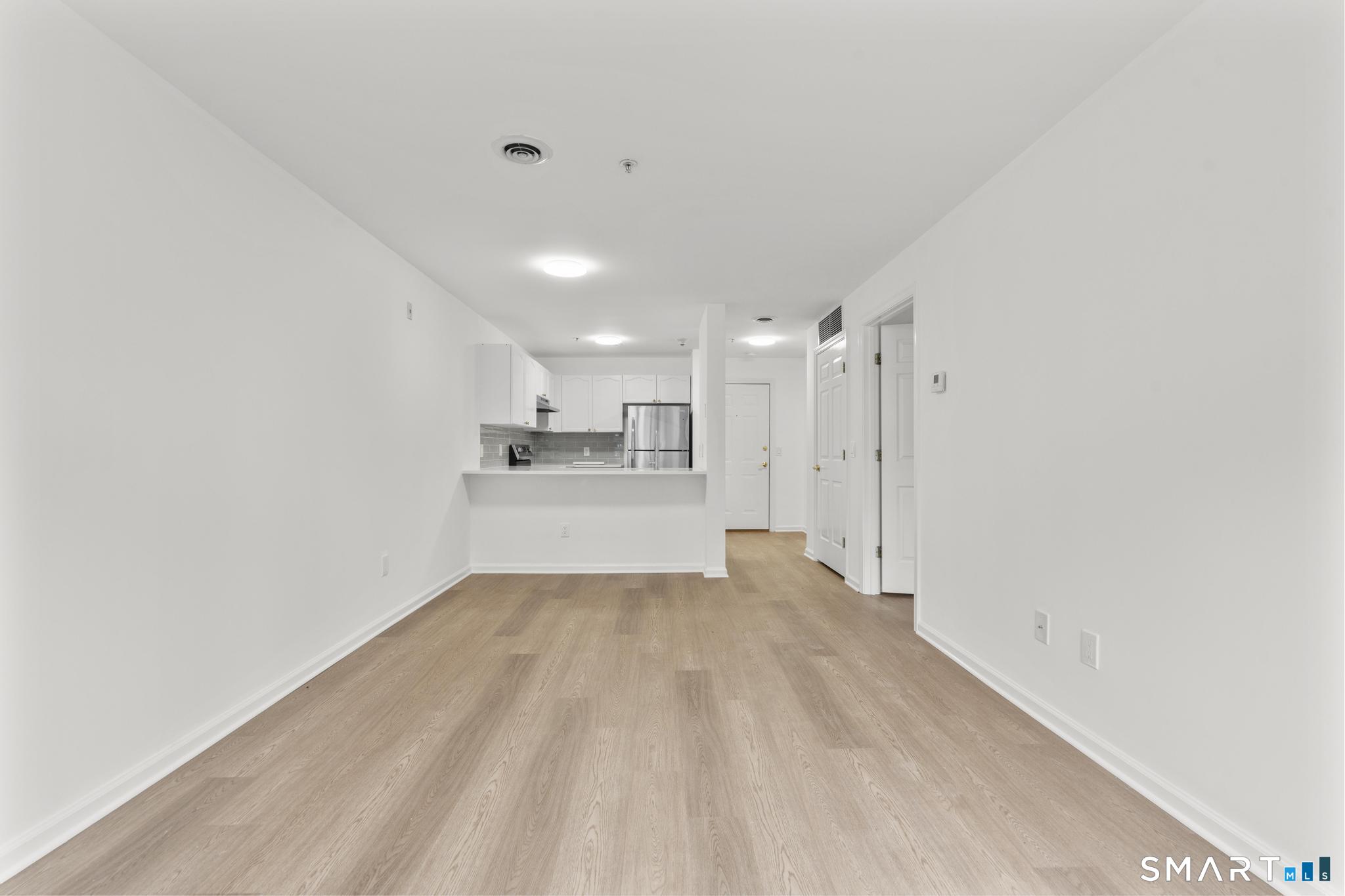 468 Main Street, Unit 111 East Lyme, CT 06357 - Photo 21 of 37 a view of a kitchen with a sink and cabinets
