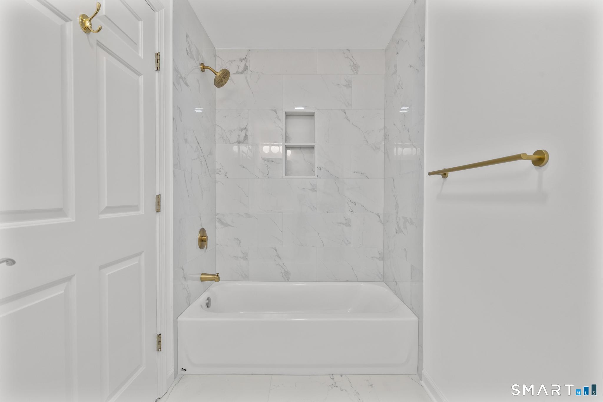 468 Main Street, Unit 111 East Lyme, CT 06357 - Photo 26 of 37 a bathroom with a bathtub