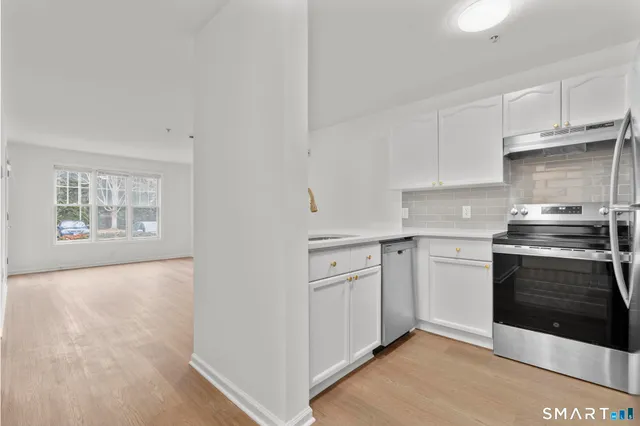 a kitchen with stainless steel appliances granite countertop a stove and a sink