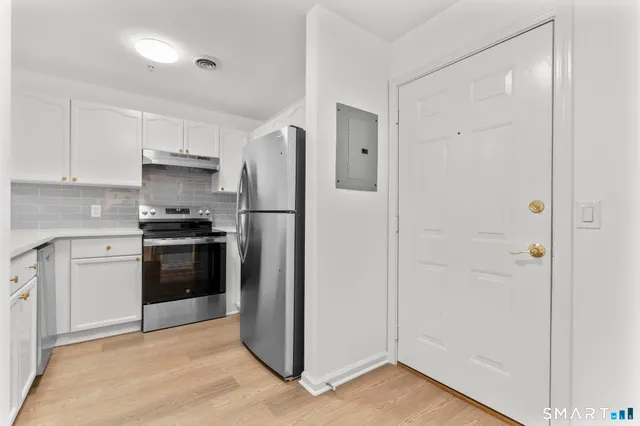 a kitchen with a refrigerator and a stove