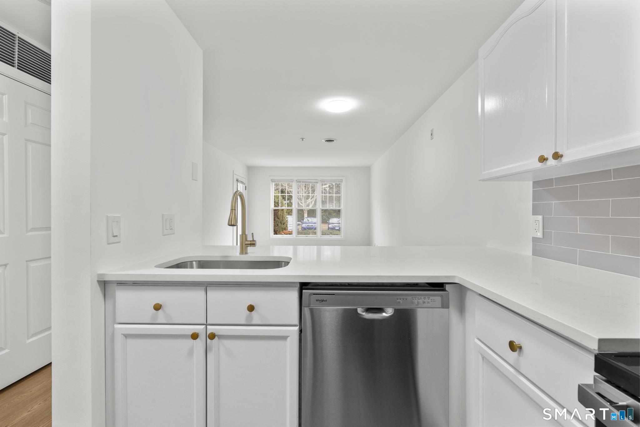 468 Main Street, Unit 111 East Lyme, CT 06357 - Photo 31 of 37 a kitchen with a sink and cabinets