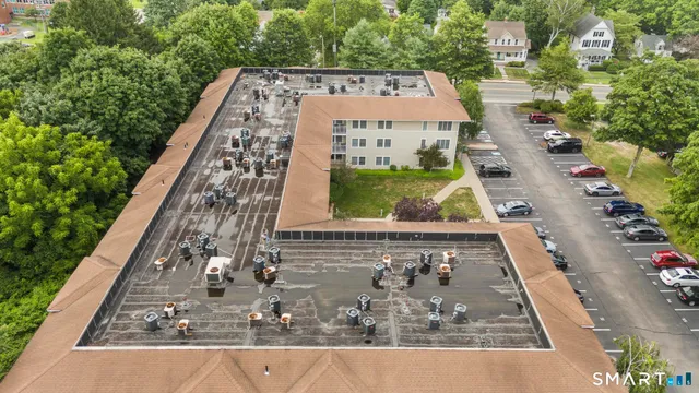 an aerial view of a residential apartment building with a yard