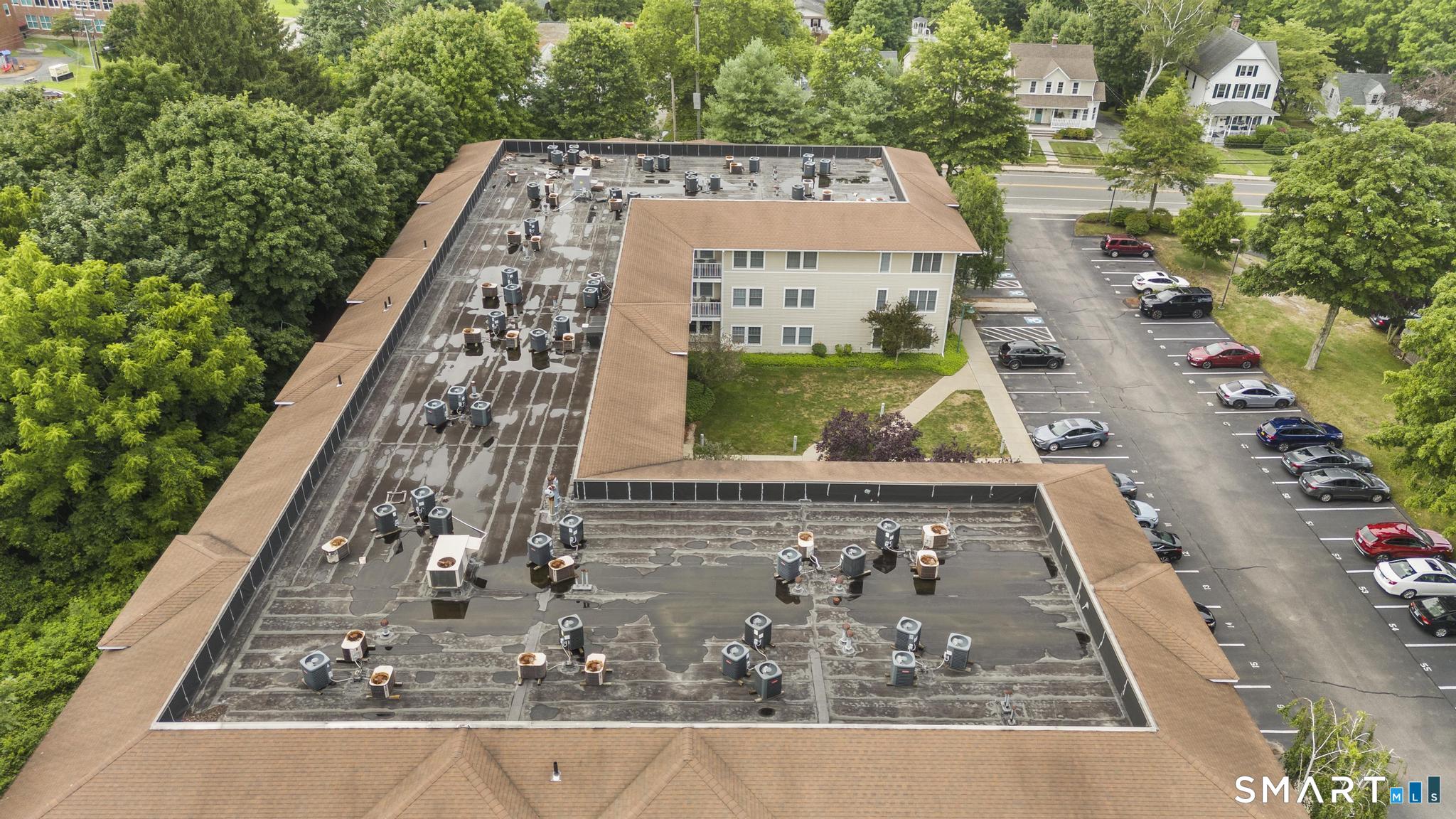 468 Main Street, Unit 111 East Lyme, CT 06357 - Photo 5 of 37 an aerial view of a residential apartment building with a yard