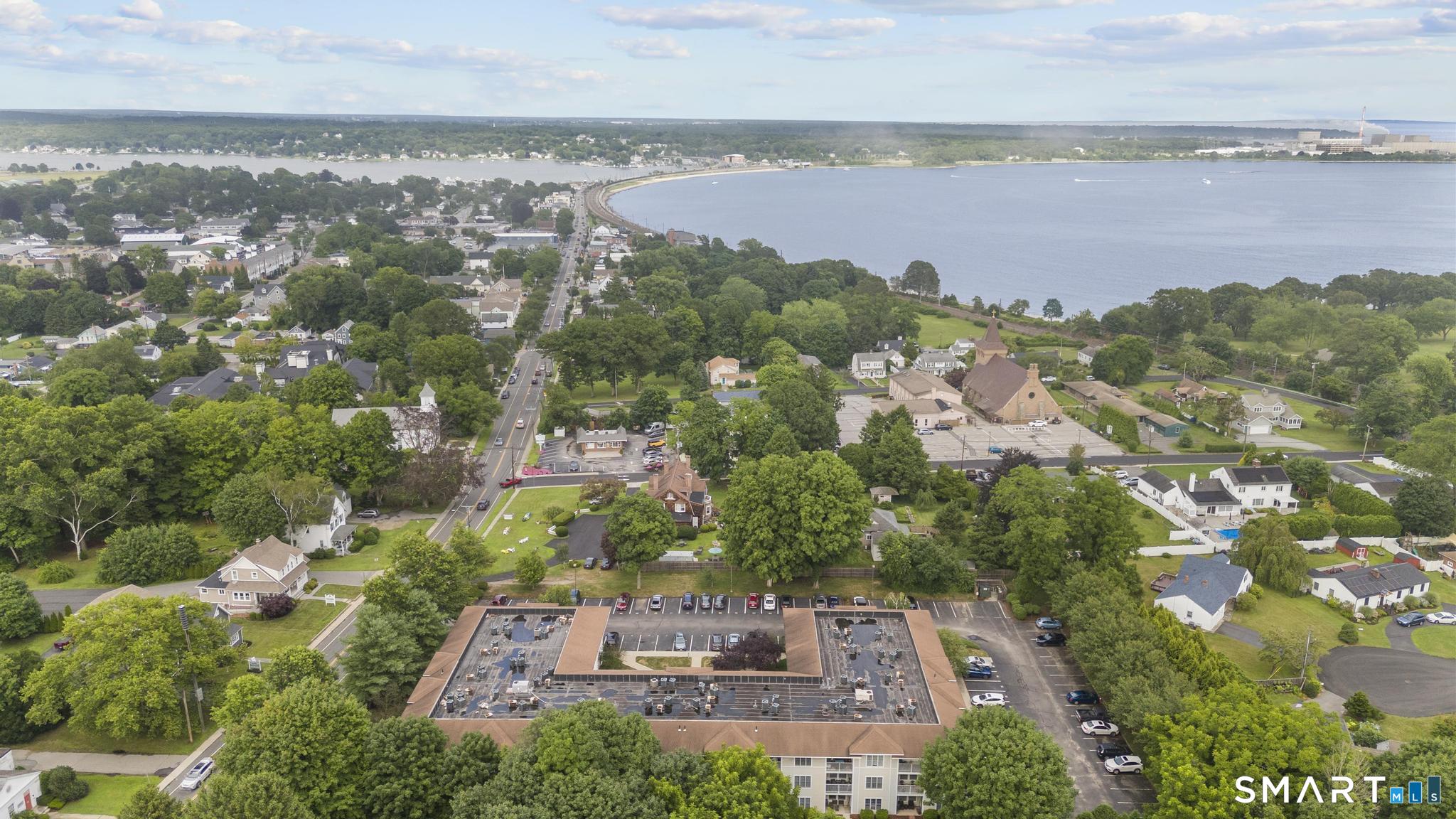 468 Main Street, Unit 111 East Lyme, CT 06357 - Photo 6 of 37 an aerial view of a house with a garden and lake view