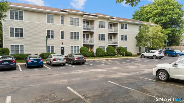a car parked in front of a white house