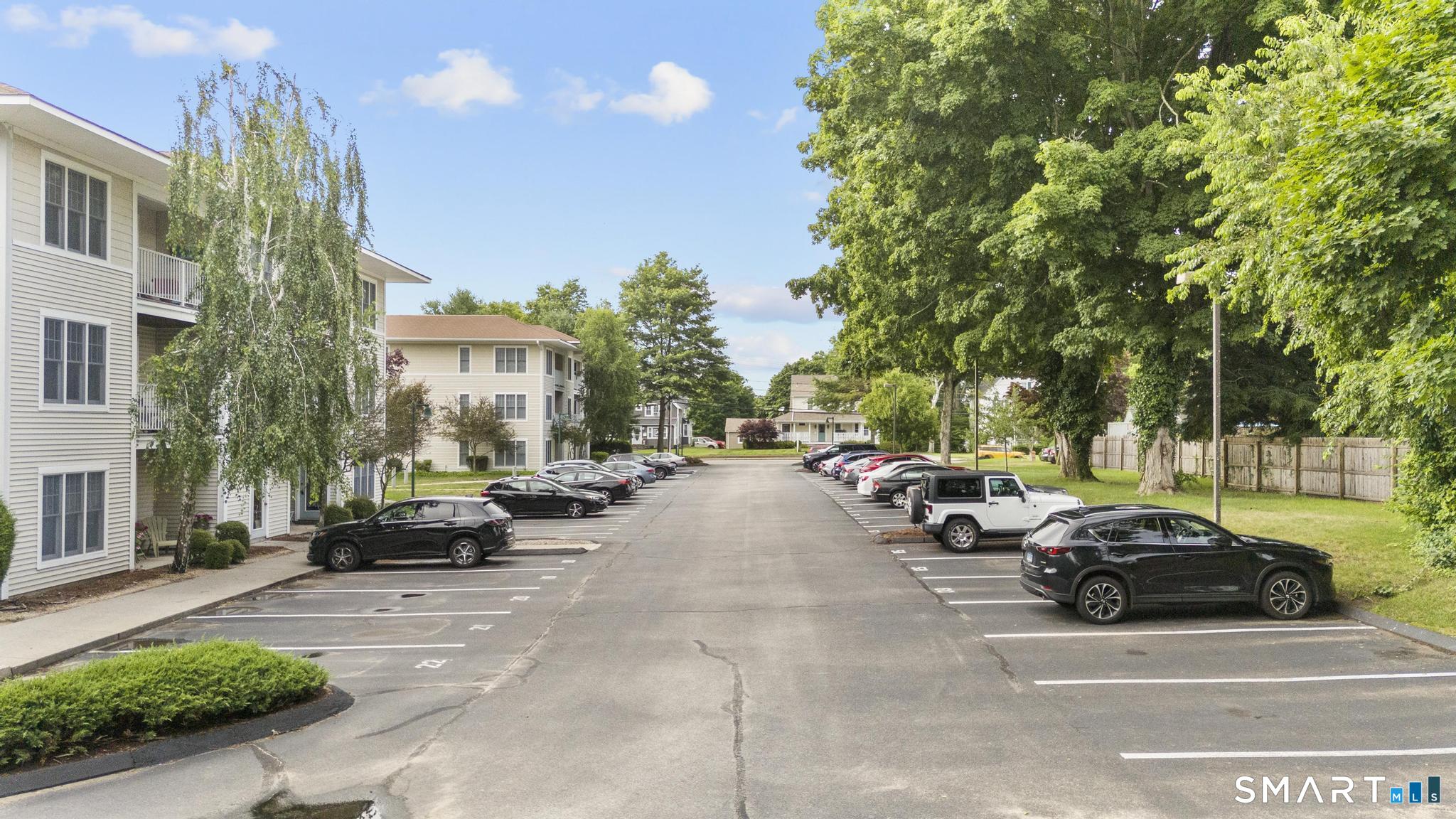 468 Main Street, Unit 111 East Lyme, CT 06357 - Photo 9 of 37 a view of road with card parked on side and retail shops