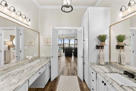 a spacious bathroom with a granite countertop sink a mirror and shower