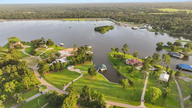 an aerial view of a house with a lake view