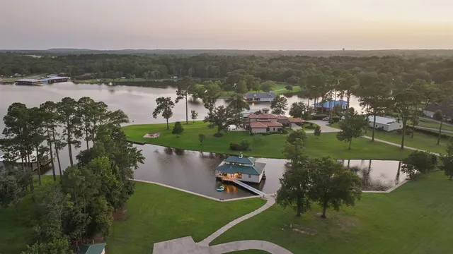 an aerial view of a house with a lake view