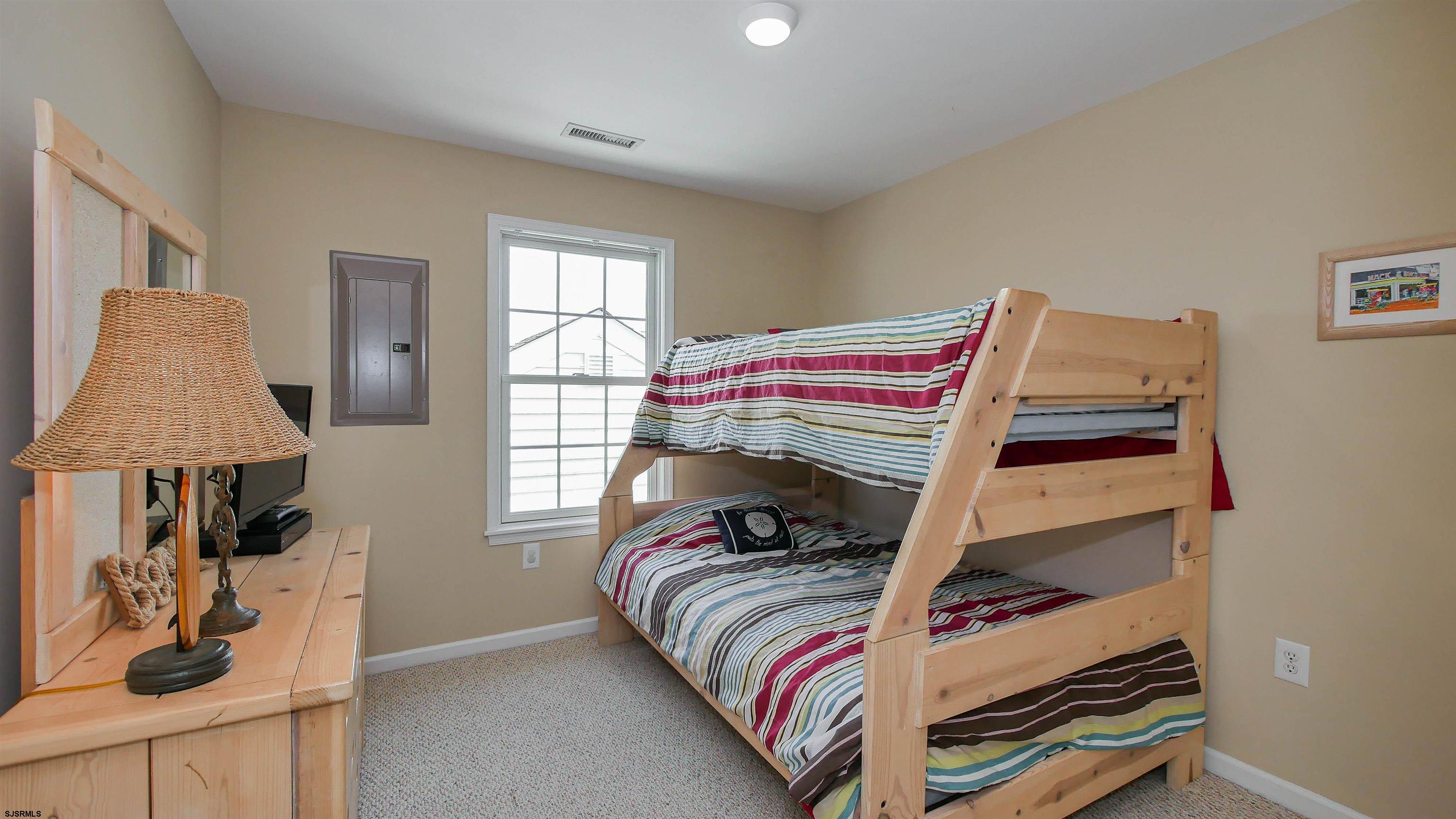 1910 Central Avenue, Unit B Ocean City, NJ 08226 - Photo 16 of 45 a bedroom with a bed and a window