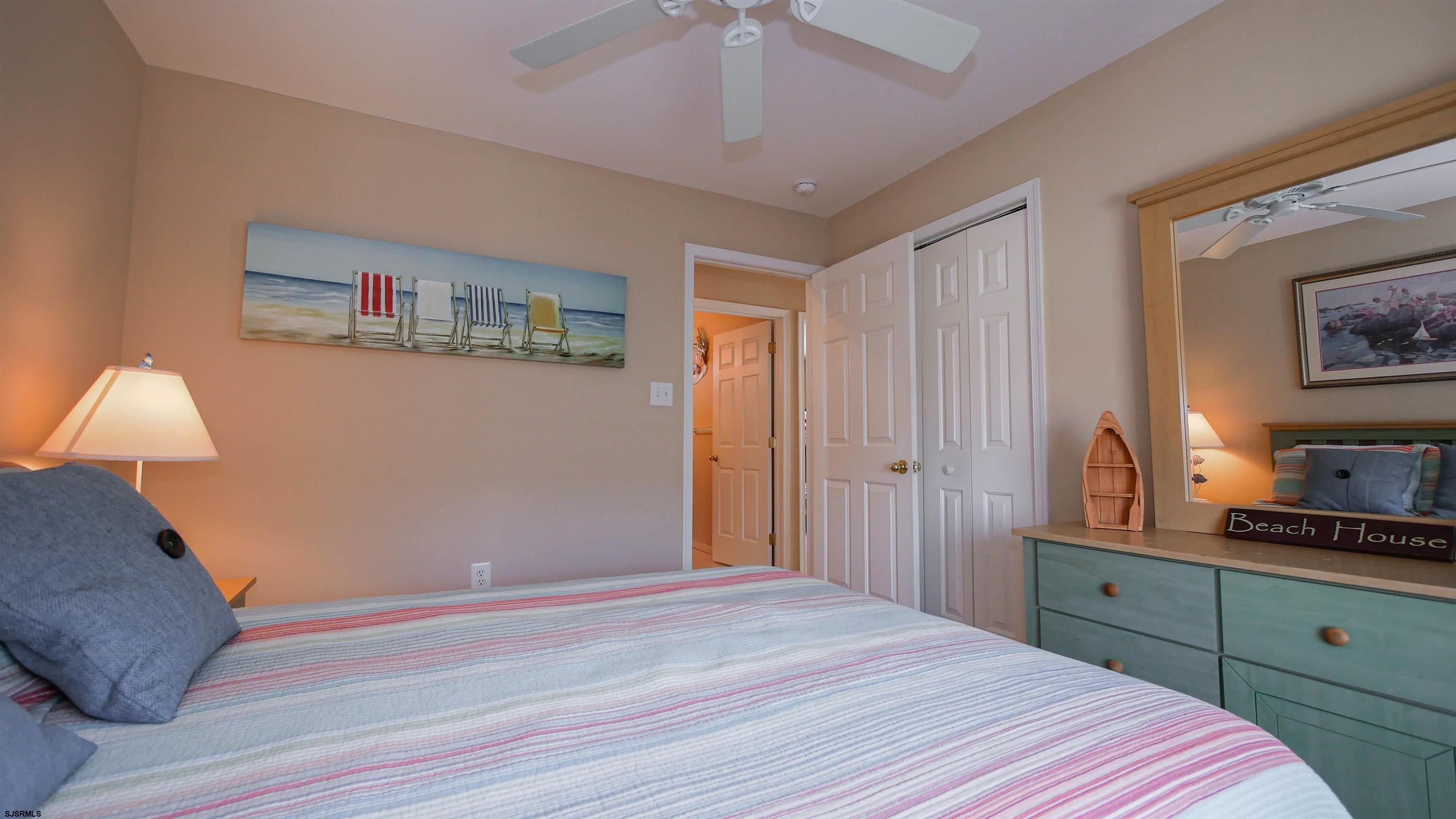 1910 Central Avenue, Unit B Ocean City, NJ 08226 - Photo 19 of 45 a bedroom with a bed and a lamp on the dresser
