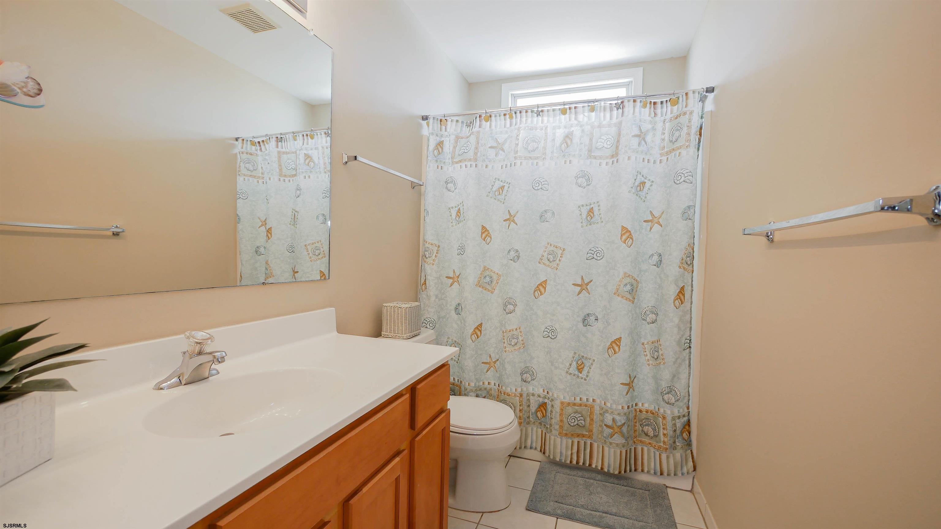 1910 Central Avenue, Unit B Ocean City, NJ 08226 - Photo 22 of 45 a bathroom with a sink toilet and shower