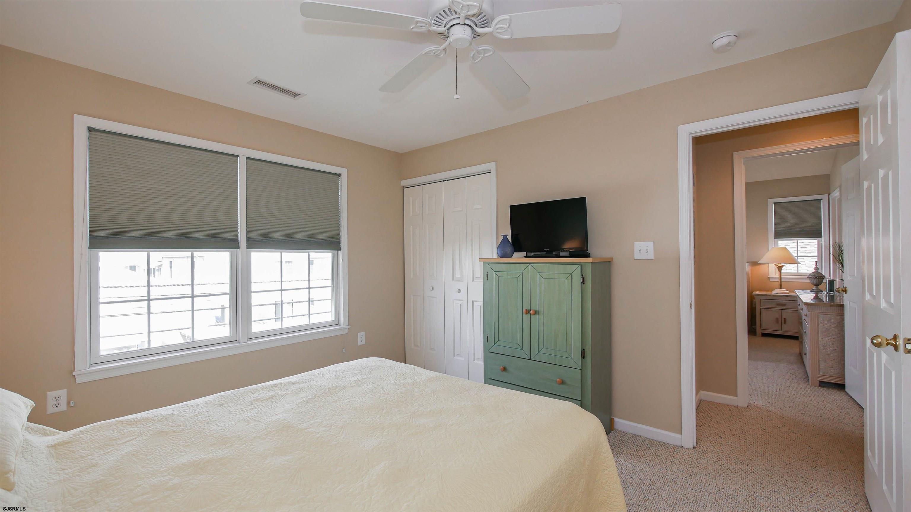 1910 Central Avenue, Unit B Ocean City, NJ 08226 - Photo 24 of 45 a bedroom with a bed and a flat screen tv