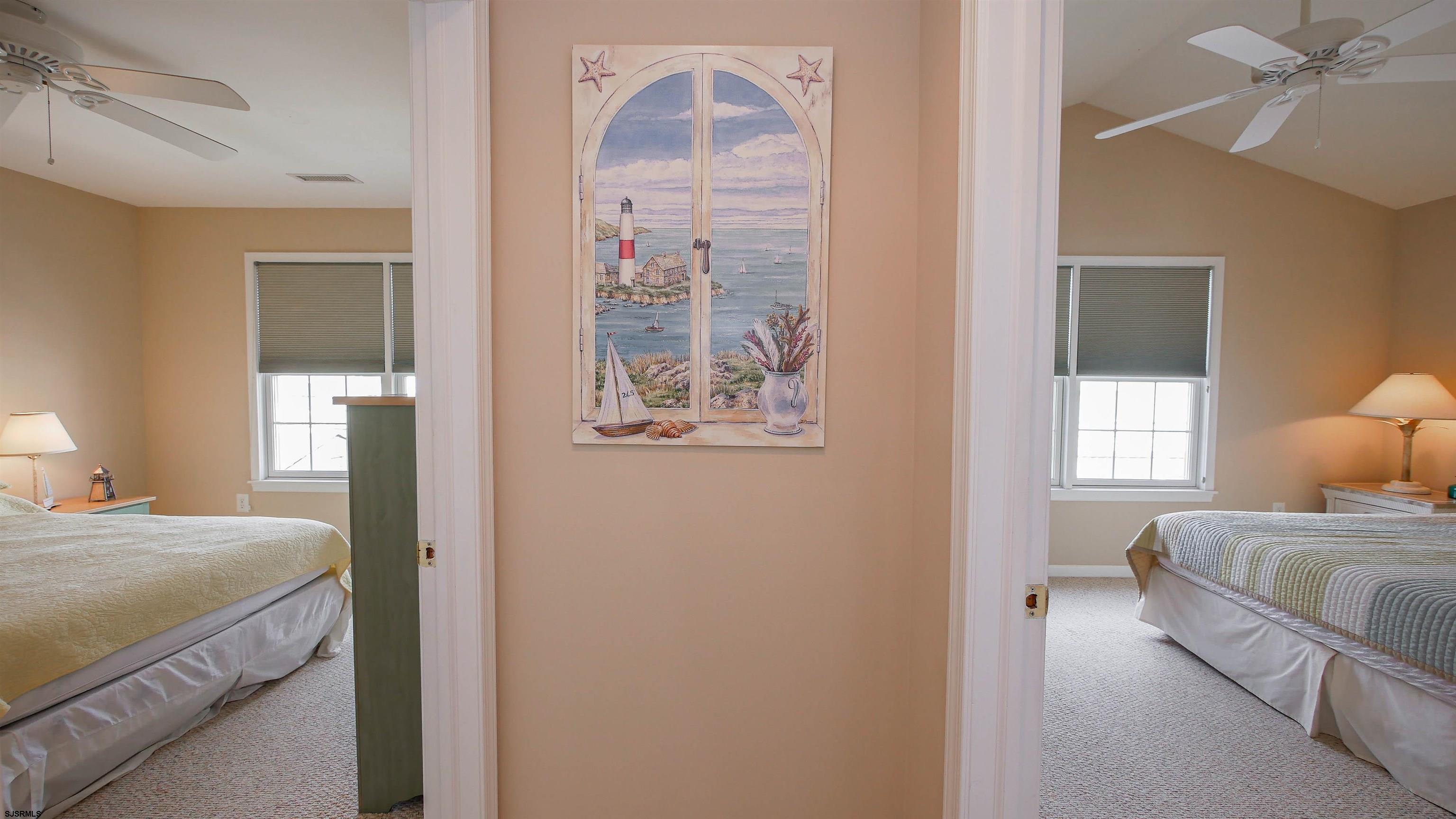 1910 Central Avenue, Unit B Ocean City, NJ 08226 - Photo 35 of 45 a bedroom with a bed and a chandelier