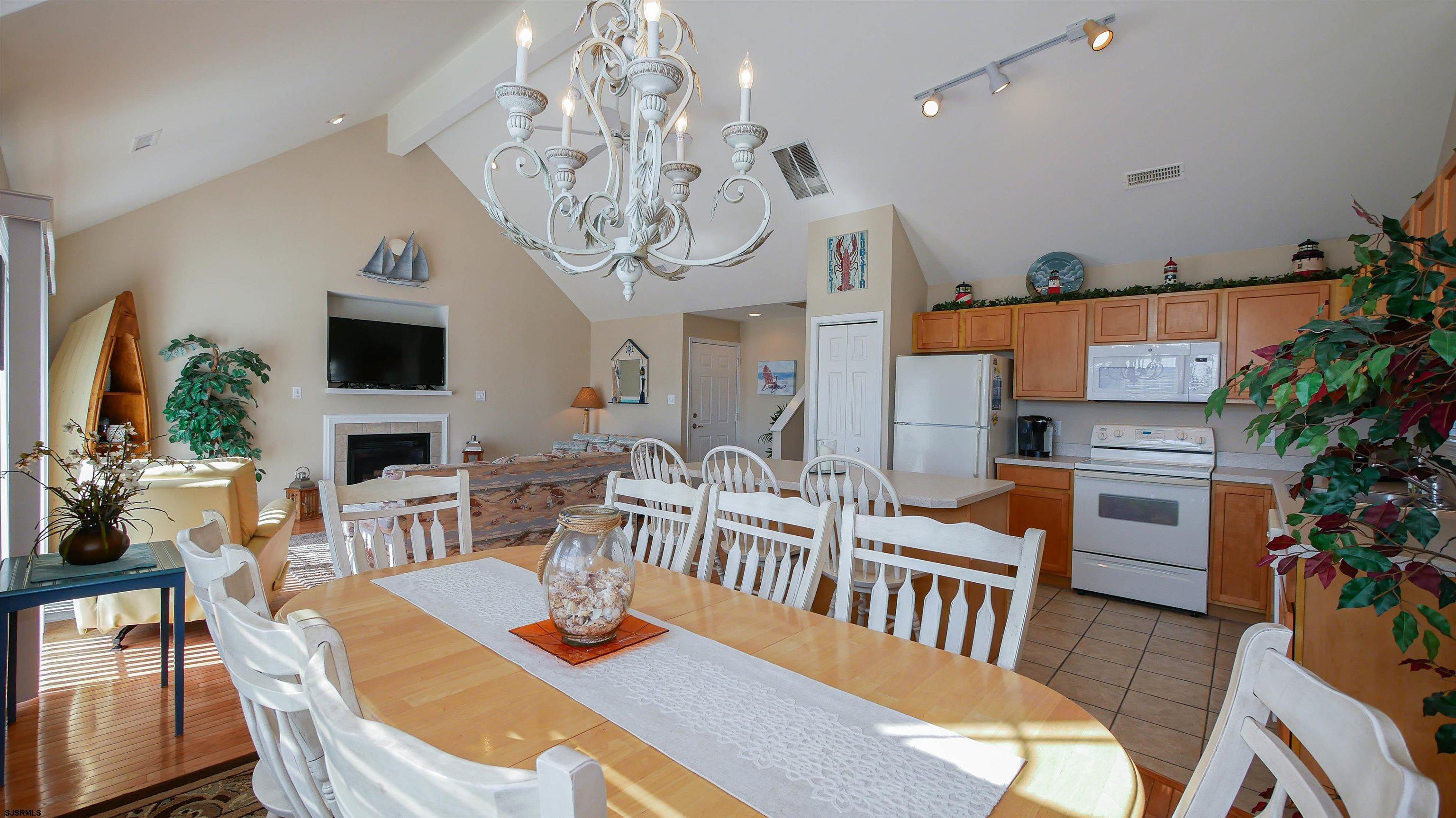 1910 Central Avenue, Unit B Ocean City, NJ 08226 - Photo 7 of 45 a view of a dining room with furniture a livingroom and chandelier