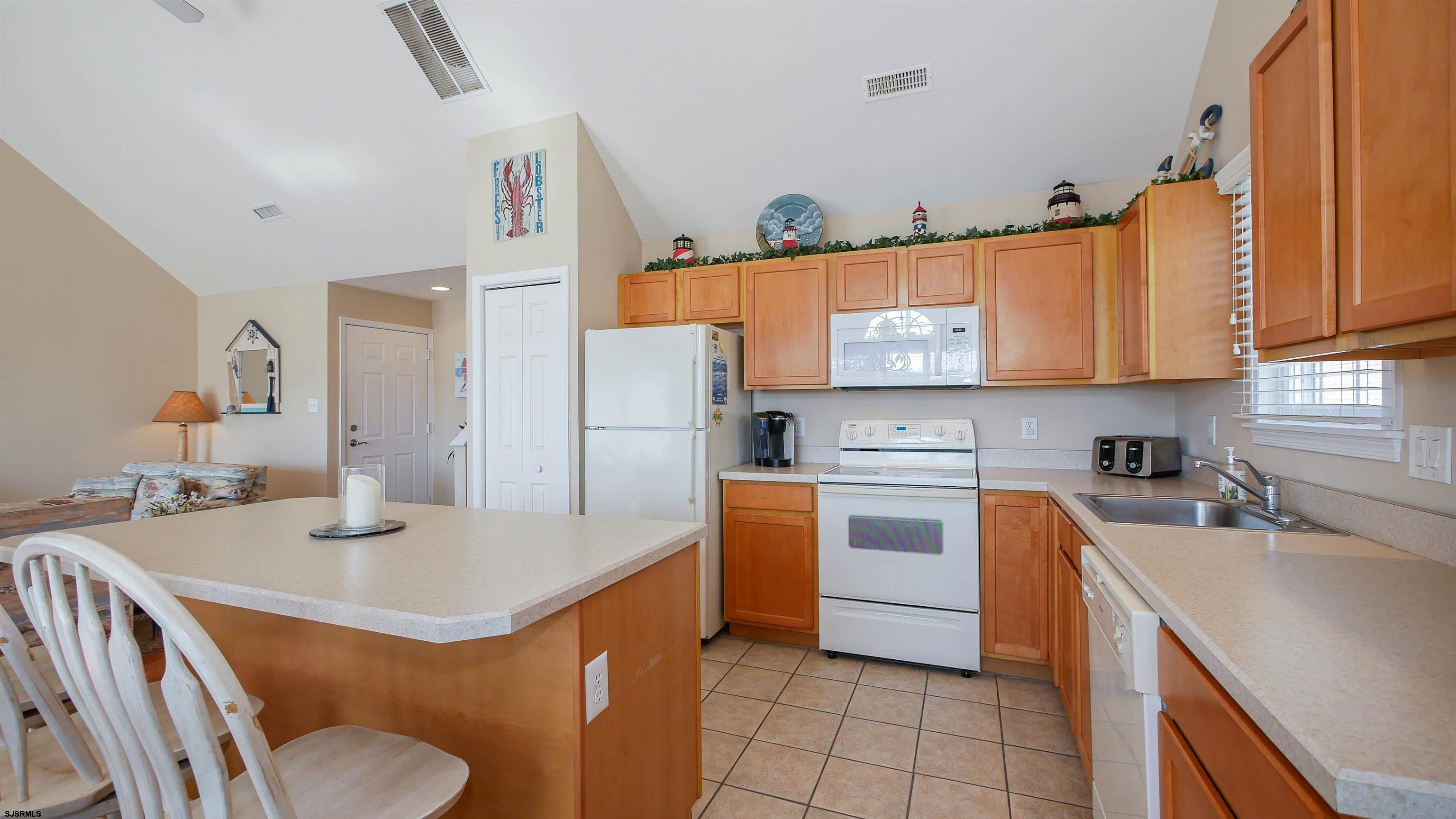 1910 Central Avenue, Unit B Ocean City, NJ 08226 - Photo 10 of 45 a kitchen with stainless steel appliances a stove a sink dishwasher and a refrigerator