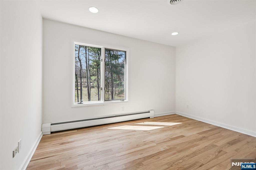 11 Carlough Road Upper Saddle River, NJ 07458 - Photo 34 of 41 an empty room with wooden floor and windows