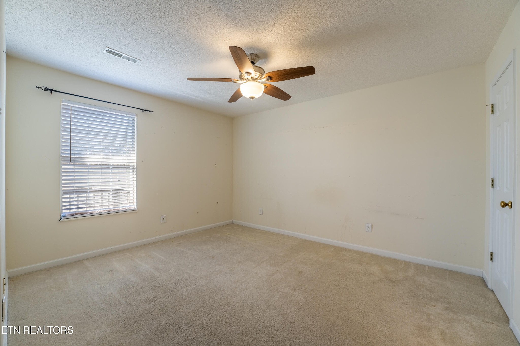 8024 Stablegate Way Powell, TN 37849 - Photo 12 of 35 an empty room with a window and a fan