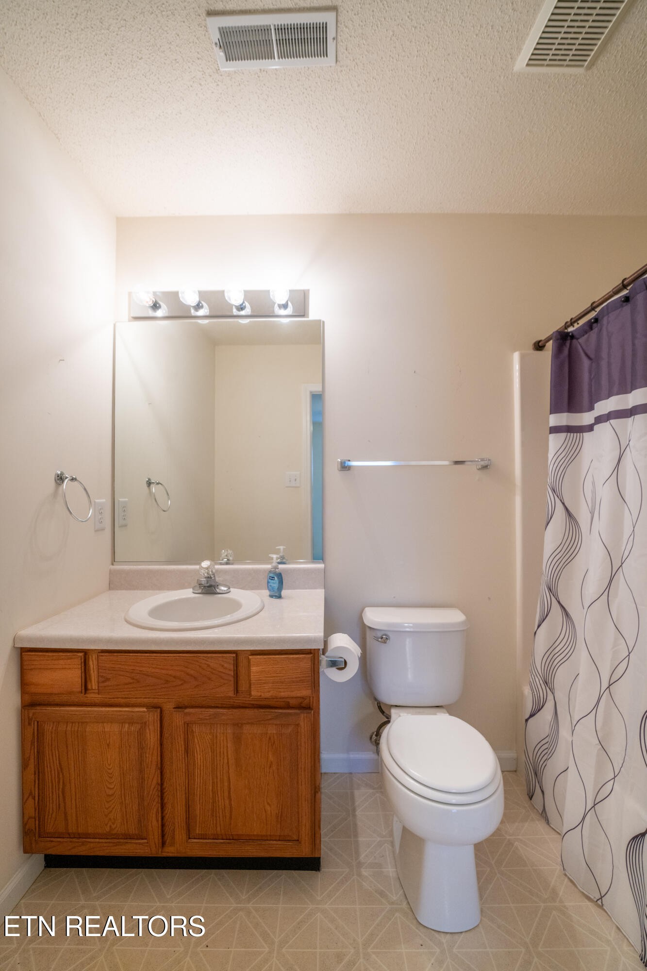 8024 Stablegate Way Powell, TN 37849 - Photo 22 of 35 a bathroom with a granite countertop toilet sink and mirror