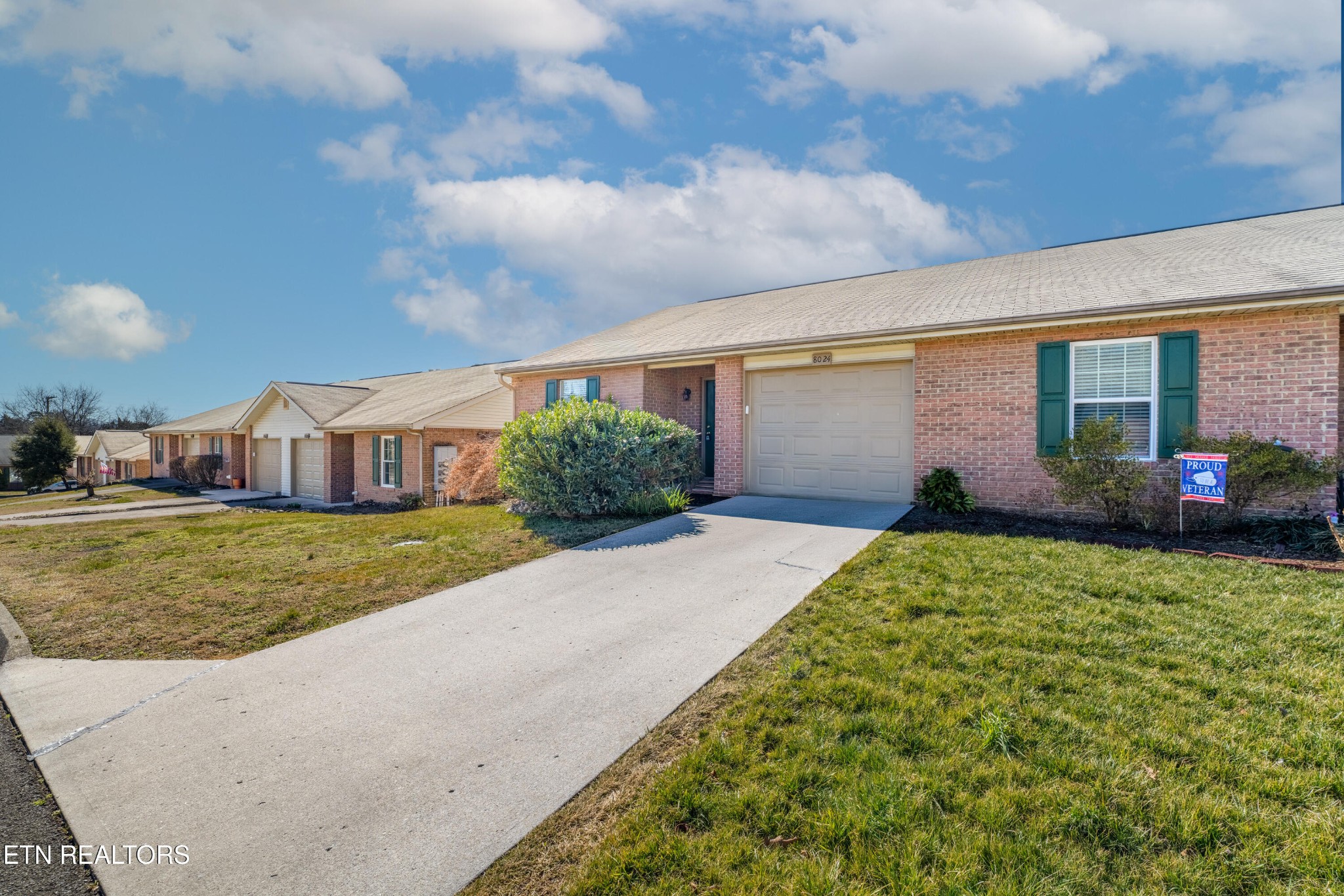 8024 Stablegate Way Powell, TN 37849 - Photo 3 of 35 a front view of a house with a garden and plants
