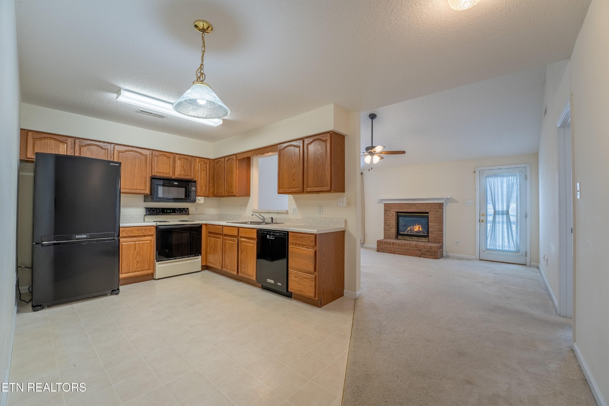 8024 Stablegate Way Powell, TN 37849 - Photo 6 of 35 a large kitchen with cabinets and stainless steel appliances