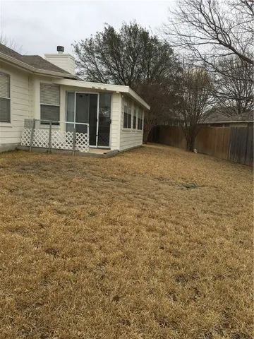 a backyard of a house with large trees