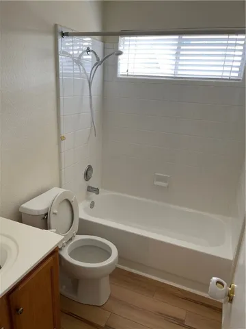 a bathroom with a toilet sink a mirror and shower