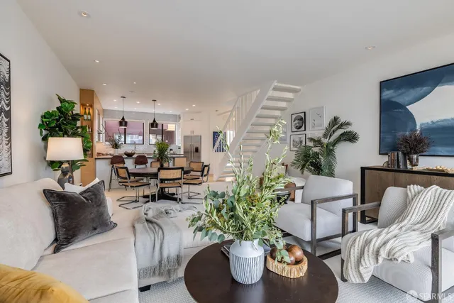 a living room with furniture and a potted plant