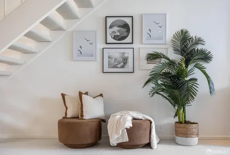 a large white kitchen with stainless steel appliances granite countertop a stove and a view of living room