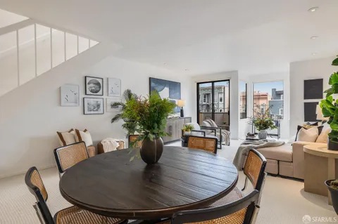 a kitchen with stainless steel appliances granite countertop a sink a stove a refrigerator and island with wooden floor