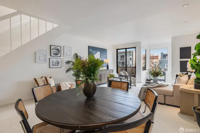 a kitchen with stainless steel appliances granite countertop a sink a stove a refrigerator and island with wooden floor