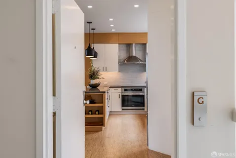 a kitchen with stainless steel appliances granite countertop a refrigerator and a stove top oven
