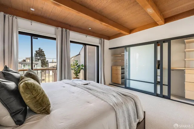a bedroom with a bed window and dresser