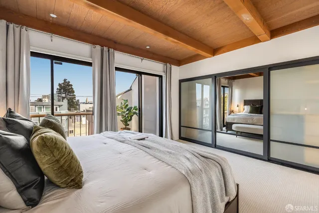 a bedroom with a large bed and a window