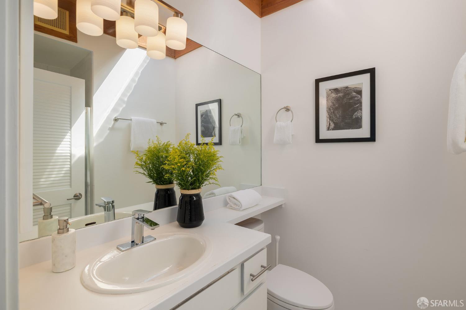 370 Church Street, Unit G San Francisco, CA 94114 - Photo 37 of 65 a bathroom with a sink toilet and mirror
