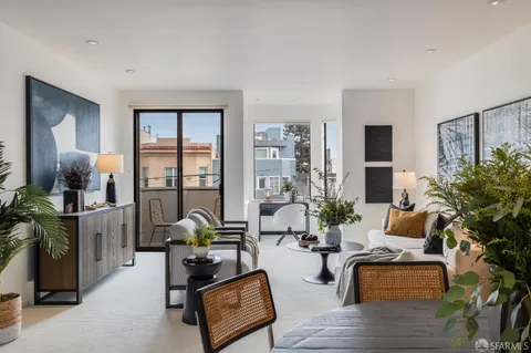 a living room with furniture and floor to ceiling windows