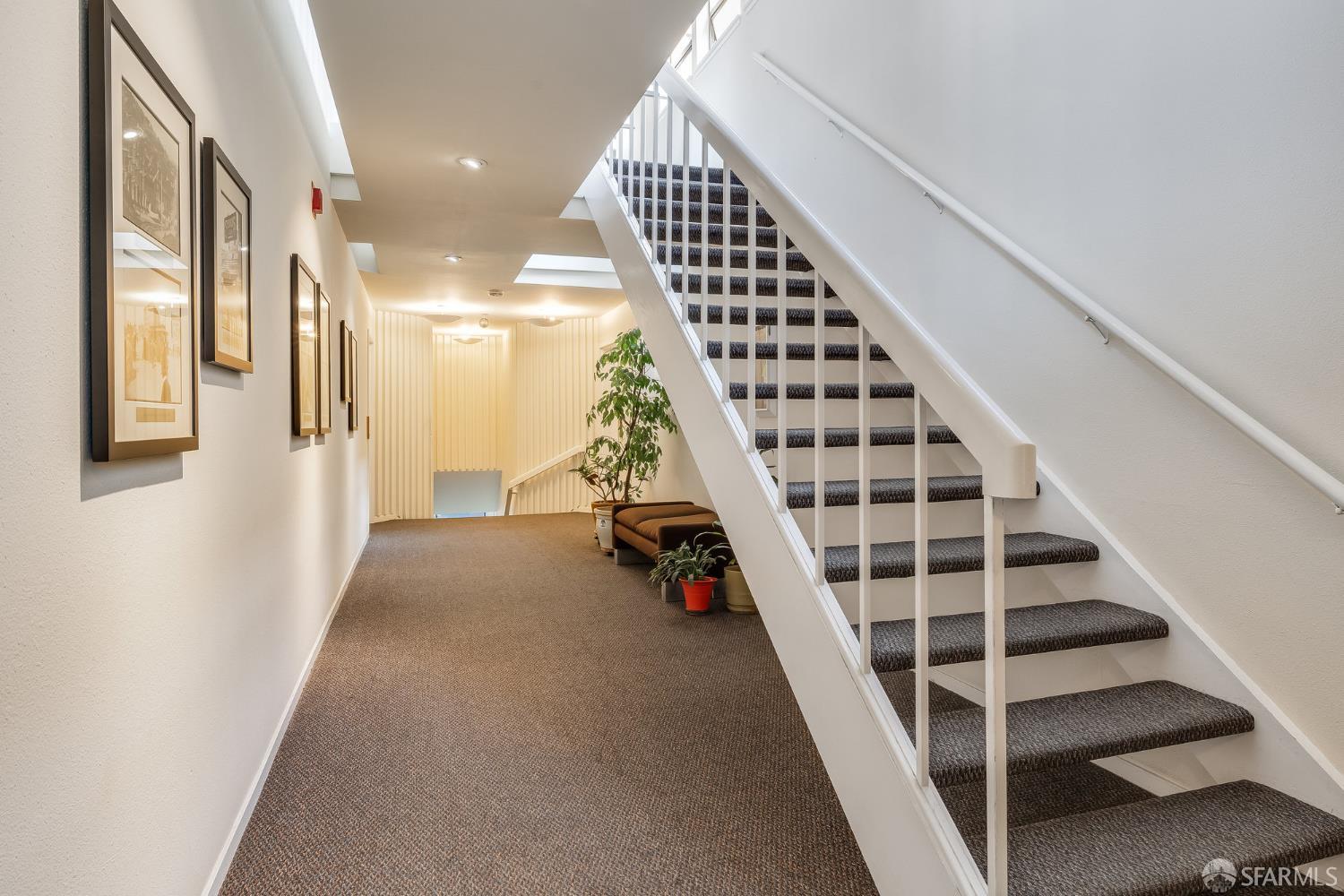 370 Church Street, Unit G San Francisco, CA 94114 - Photo 51 of 65 a view of staircase with wooden floor and lots of frames on wall