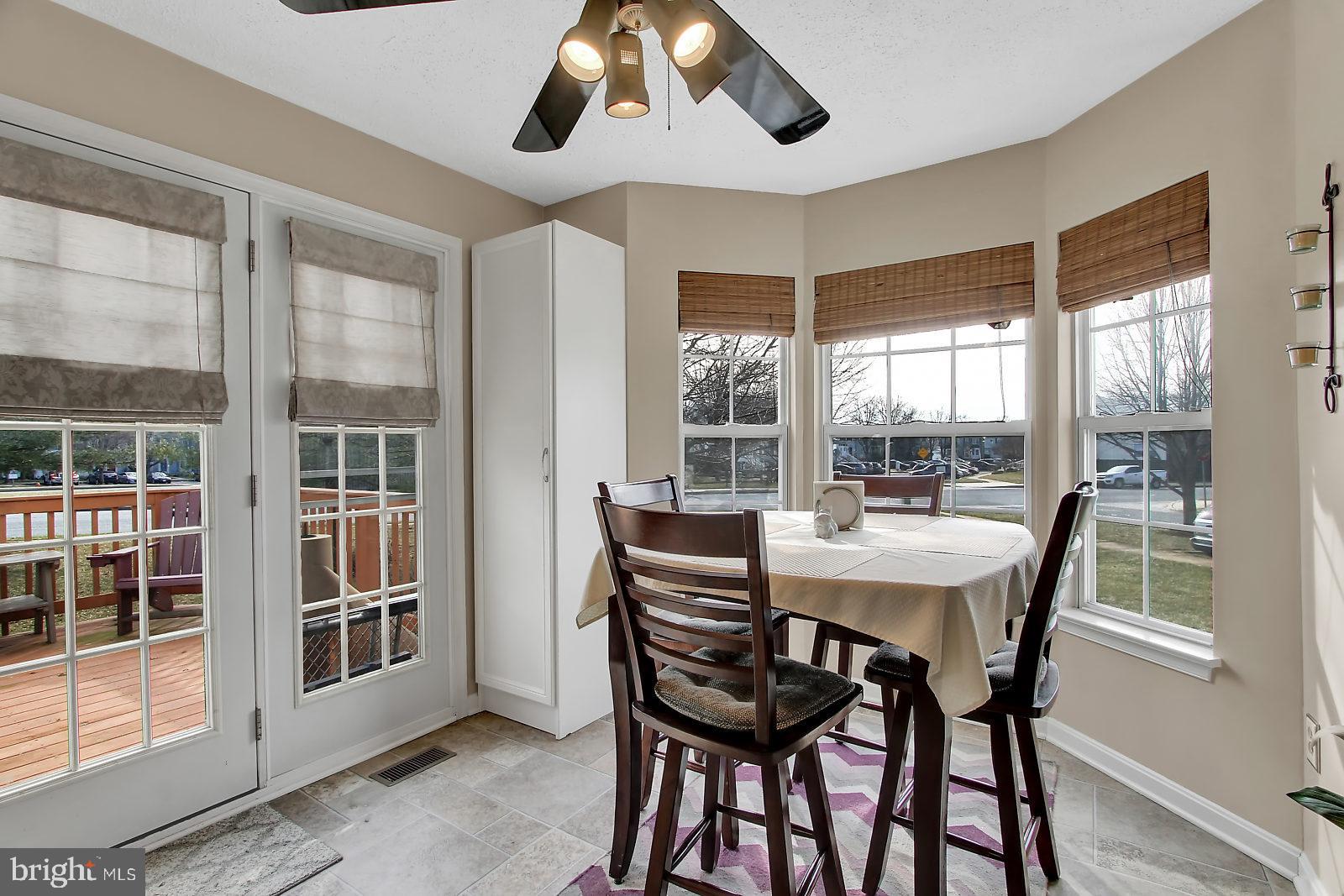 2101 Riding Crop Way Baltimore, MD 21244 - Photo 5 of 36 a view of a dining room with furniture wooden floor and chandelier