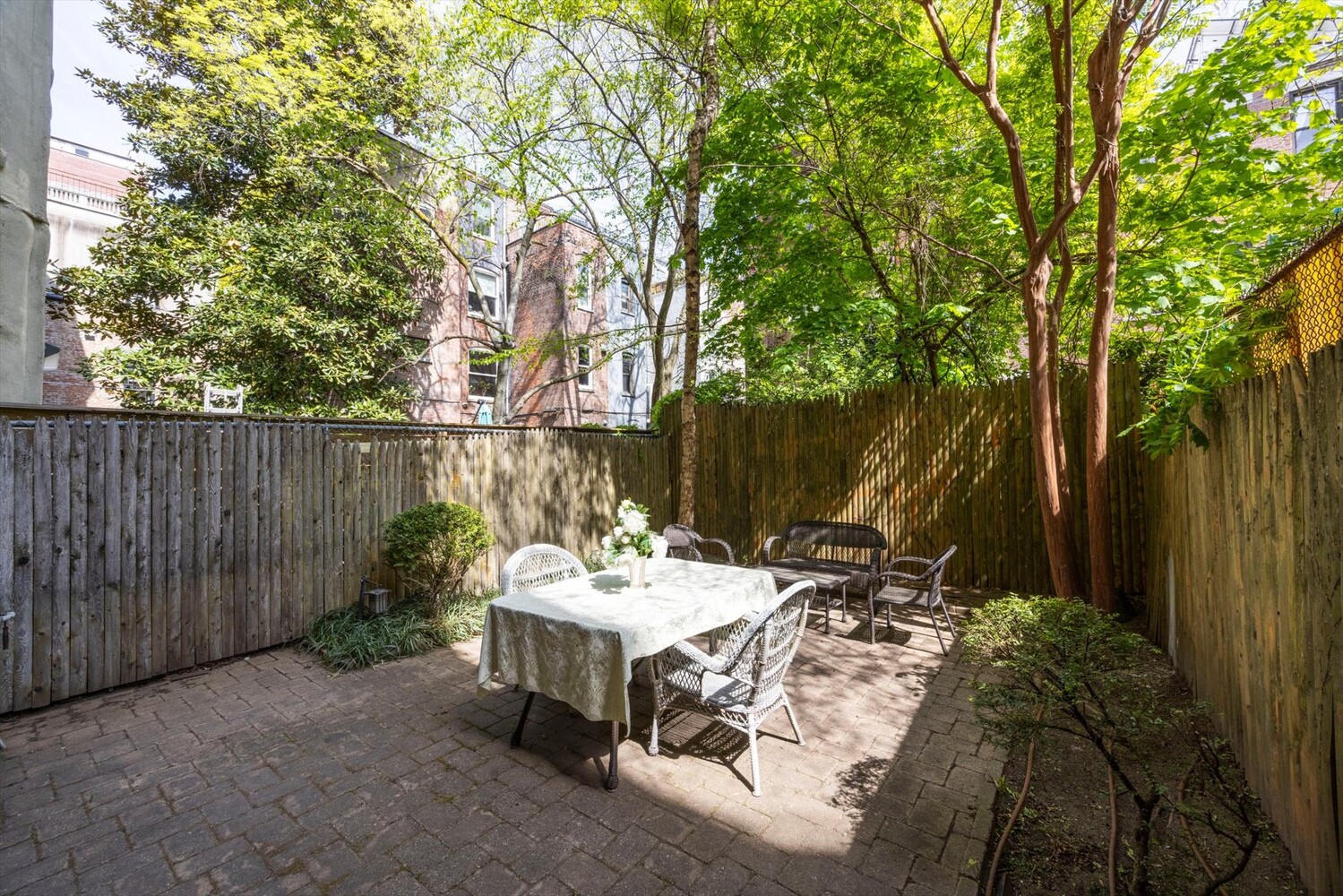 329 Convent Avenue Manhattan, NY 10031 - Photo 13 of 28 a view of a dinning table and chairs in the garden