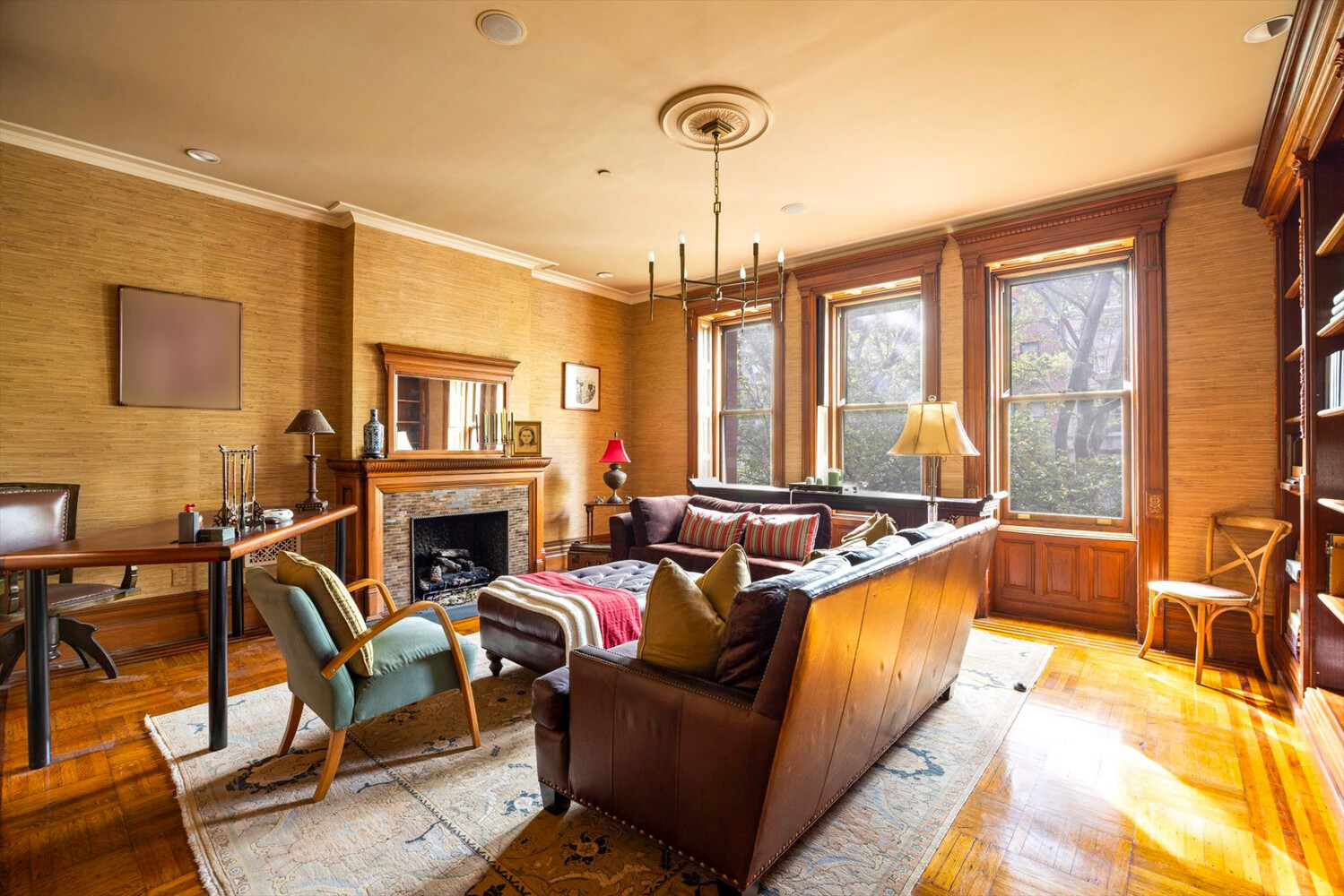 329 Convent Avenue Manhattan, NY 10031 - Photo 18 of 28 a living room with furniture a fireplace and a chandelier